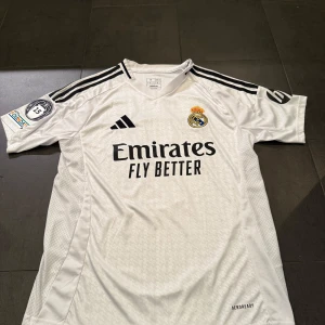 Real Madrid Mbappé matchställ Adidas - Real Madrid set med Mbappe på ryggen nummer 9. Går att köpa bara tröjan utan shorts men set säljes. Bara tröjan 399, tröja+shorts 600 kr. Priset är diskuterbart!