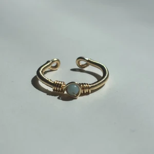 Amazonite Ring - Denna ring är tillverkad för hand med rostfri ståltråd som gör den slitstark och motståndskraftig mot rost. Den är justerbar för en perfekt passform och smyckad med pärlor av äkta blå amazonit – vilket ger ett vackert och naturligt uttryck. Ringen är dessutom vattentålig och passar perfekt för vardagsanvändning.