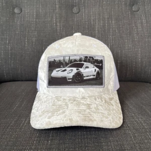 Vit velvet keps med en porsche  - Säljer en vit velvet keps med en porsche 911 gt3 rs.  Passar perfekt inför sommaren 🏝️🌅. Hör av er om ni har några frågor. 