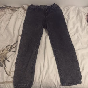 Svart-Gråa jeans från Grunt - Säljer ett par svarta jeans från Grunt med klassisk femficksdesign och raka ben. Jeansen har normal passform och är tillverkade i ett slitstarkt denimtyg. Jeansen är köpa hos KidsBrandStore och pris kan diskuteras