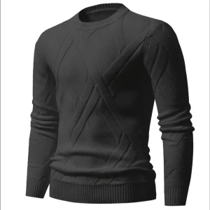 Unik svart stickad tröja med strukturmönster - Säljer en svart stickad tröja med diskret strukturmönster och rund hals. Tröjan har långa ärmar och ribbade muddar vid ärmslut och nederkant. Perfekt för en stilren och enkel look.