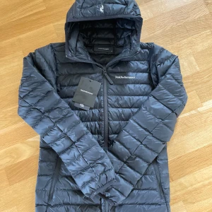 Svart dunjacka från peak performance XS - Tjena! Säljer denna dunjackan för tjejer från peak performance. Denna jackan är perfekt för dig som vill ha en helt ny och snygg jacka till skolstarten. Jackan är helt ny så alla lappar sitter kvar på den. Den är storlek Xs. Nypris 2800kr mitt pris 1850kr. Pris kan diskuteras vid snabb affär.
