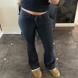 Svarta lågmidjade bootcut jeans  - Snygga svarta jeans från Vero Moda i bootcut-modell i storlek S. Jeansen är lågmidjade och i ett stretchigt material. De är slitna nere vid hälen men annars inga defekter. Som referens är jag 165 cm och brukar ha storlek 36 i jeans😊