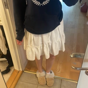 Vit volangkjol  - Superfin vit kjol med volang. Kjolen har elastisk midja med snörning och tofsar, lappen e tyvärr borta så vet ej storlek men är lite stor för mig som har S. Skulle säga att M/L passar bäst🌟
