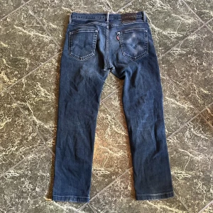 Blåa Levis 511 - Säljer ett par Mörkblå Levis i modell 511. Storleken är 32 34 fast passar igentligen 30 32. Ända defekten är nedanför gylfen är det 2 hål.  Nypris är ungefär 1200kr. Hör av dig vid flera frågor eller bilder.