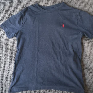 Mörkblå t-shirt från Polo Ralph Lauren - Säljer en stilren mörkblå t-shirt från Polo Ralph Lauren. Endast använd några få gånger) T-shirten är skön och slät och är gjord av len bomull