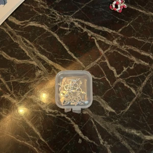 Silverfärgade berlocker med hjärtan och nycklar - Säljer ett set med silverfärgade berlocker. Setet innehåller hjärtformade lås med små vingar och matchande nycklar, perfekta för att skapa personliga smycken. Perfekt för DIY-projekt eller som en unik present.