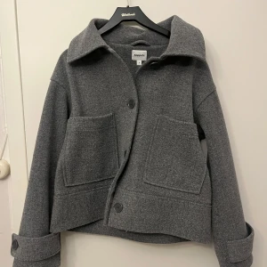 Grå kappa - Snygg grå kappa från Kappahl med stora fickor framtill och knappar. Perfekt vårjacka. Nypris 900