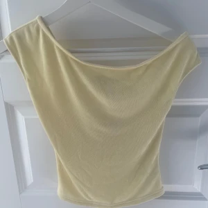 Gul offshoulder topp från Edikted - Superfin ljusgul offshoulder topp från Edikted. Toppen har en tight passform och ska vara lite lös upptill. Säljs med originaltag kvar och aldrig använd. 