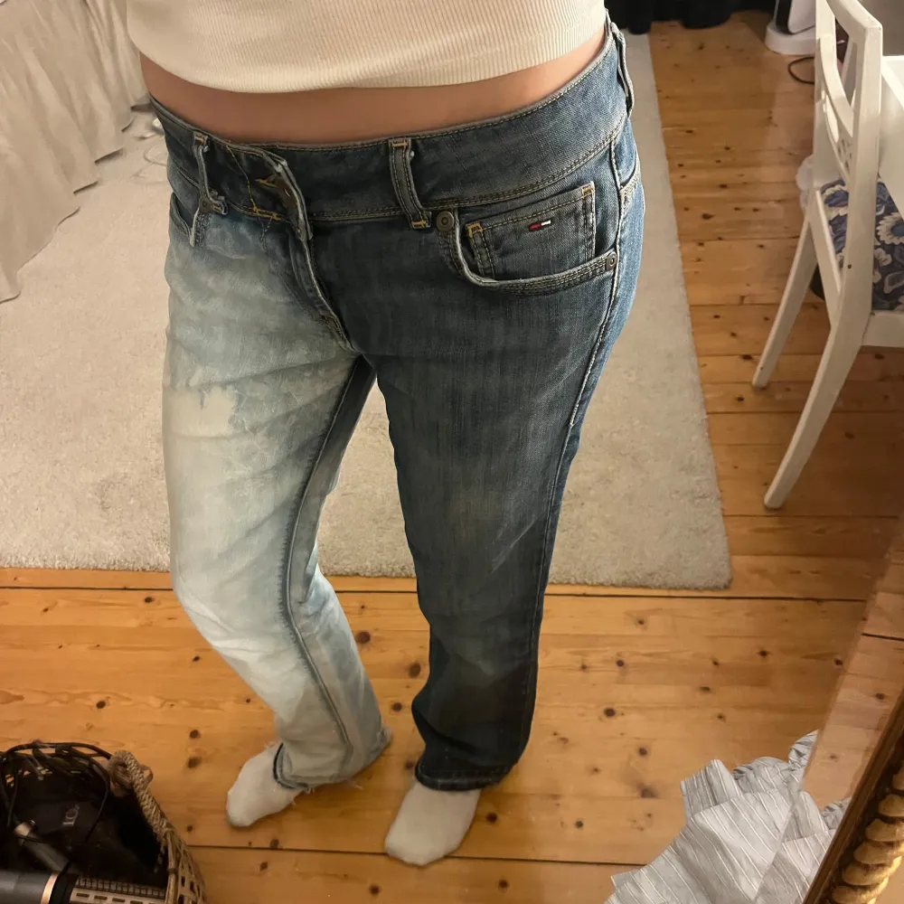 Coola och unika jeans från Tommy Hilfiger med en unik tvåfärgad design. Ena benet är mörkblått och det andra ljusblått. Jeansen har en straight/bootcut passform och klassiska femficksdetaljer. 💕Ytterbensmått 102 cm Innerbensmått 81 cm Midjemått 41 cm rakt över. Farkut & Housut.