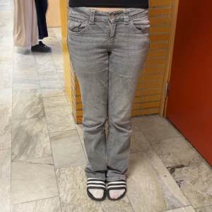 Grå jeansbyxor - Snygga grå jeansbyxor med en klassisk femficksdesign. De har en normal passform och är perfekta för en avslappnad stil. Byxorna har en knapp- och dragkedjestängning framtill använt några gånger.