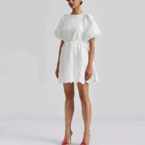 Vit kortklänning med puffärmar och öppen rygg - Superfin vit kortklänning med puffiga kortärmar. Klänningen är från By malina å endast använd på studenten! Lånade bilder!!