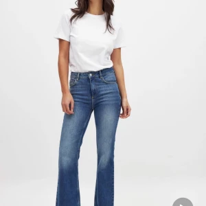Blå bootcut jeans med hög midja - Helt oanvända jeans, nya med prislapp från Nakd i storlek 38