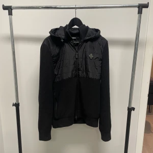 J.Lindeberg Cardigan - Svart JL cardigan med huva i väldigt fint skick förutom små noppringar på vissa ställen vilket inte märks av. Populär slutsåld model. Byten kan vara intressant.
