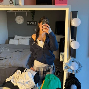 Mörkblå hoodie med dragkedja - Säljer en mörkblå hoodie med dragkedja. Den har långa ärmar och en bekväm passform. Perfekt för en avslappnad stil. ” den har fått klorin fläckar på luvan” 