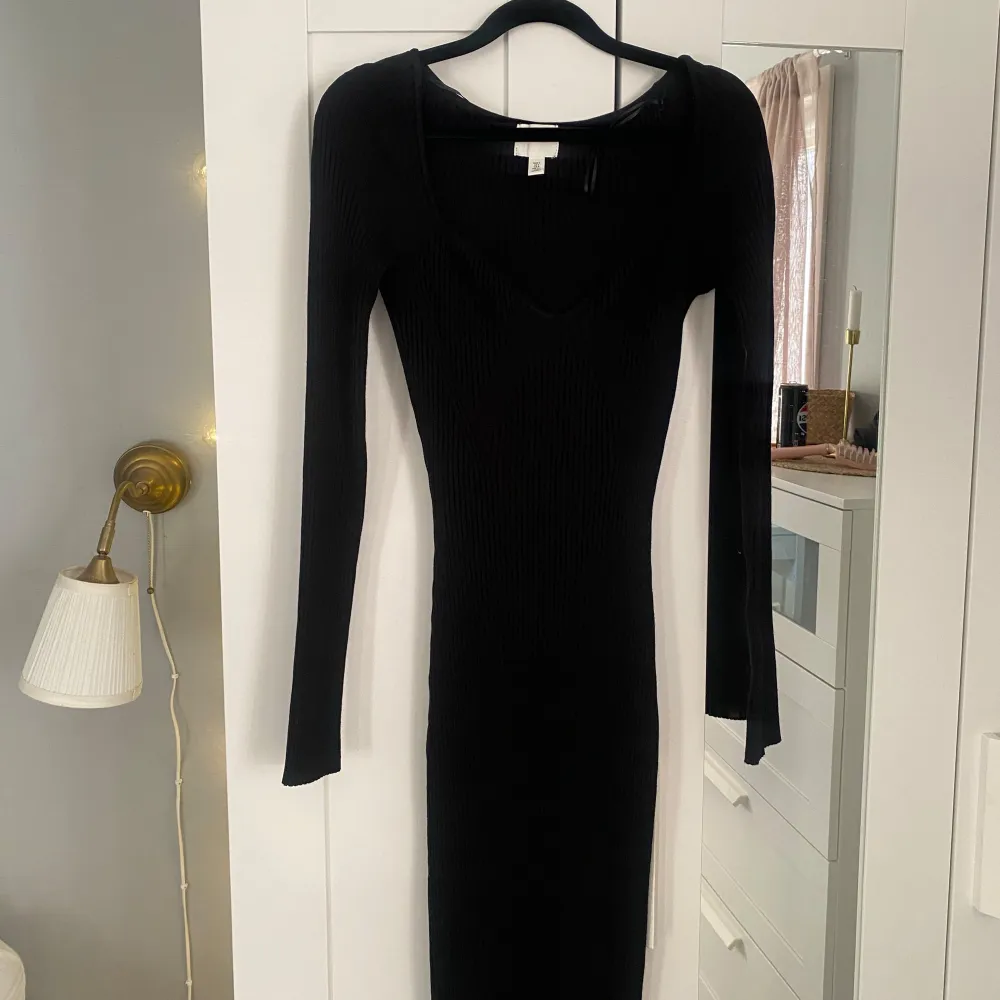 Snygg svart stickad ribbad klänning med lång ärm och v-ringad design. Klänningen har en tight passform som framhäver figuren. Jag är 176 cm lång och den slutar liten bit under knäna. Säljer då den tyvärr inte kommer till användning mer💓. Mekot.