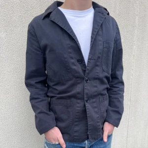 Mörkblå overshirt från Aspesi - Snygg blå overshirt/blazer med tre knappar framtill och flera praktiska fickor. Perfekt för en stilren look. Passar bra till jeans eller mer formella byxor.  Hör av er vid frågor!👍