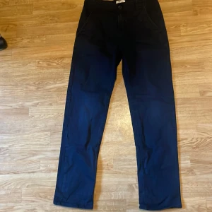 Mörkblå byxor från Lindex - Snygga mörkblå byxor från Lindex i en klassisk stil. De har en normal passform och är tillverkade i ett bekvämt material. Perfekta för en stilren look.