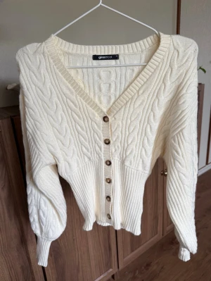 Stickad cardigan - Så fin cardigan, använd en gång. Den är gräddvit i färgen, mycket bra skick!