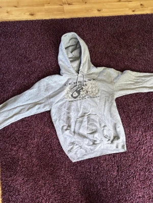 Grå hoodie med tryck  - Säljer en sällsynt grå hoodie från Cersant som inte längre säljs. Perfekt för chill dagar eller när du vill ha en avslappnad stil.    Hör gärna av dig vid minsta fundering. Priset kan diskuteras.