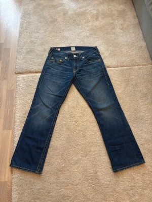 True Religion Jeans strl 34 - Mörkblåa True Religion Jeans. Mycket bra skick endast använda två gånger. Mått och labels finns på bilderna!