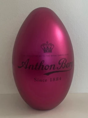 Rosa påskägg från Anthon Berg - Säljer ett stort, metalliskt rosa påskägg från Anthon Berg. Ägget har en blank yta och texten 'Since 1884' tryckt på framsidan tillsammans med en krona. Perfekt som dekoration eller för att fylla med godis.