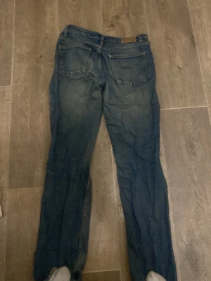 Mörkblå raka jeans - Säljer ett par mörkblå jeans med rak passform och klassiska fem fickor. Jeansen har normal midja och är tillverkade i denim. Perfekta för dig som gillar en enkel och tidlös stil.