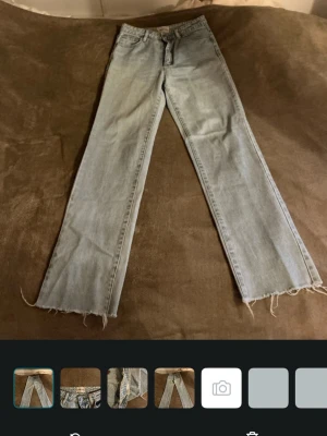 Ljusblå raka jeans från Abrand - Säljer ett par ljusblå jeans från Abrand Jeans med raka ben och råa, fransiga benslut. Klassisk femficksmodell i mjuk denim med dragkedjegylf och knapp. Perfekta för en avslappnad och trendig look.