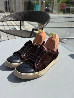 Lanvins  - Snygga Lanvins i Vin röd mocka med glans och vita sulor. Perfekta för dig som gillar en stilren och avslappnad look med en touch av premiumkänsla. Passar 41
