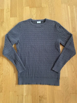 John Henric tröja - Säljer en stilren långärmad kabelstickad tröja från John Henric. 🧶 Mörkgrå färg som passar till det mesta och är perfekt för både vardag och finare tillfällen. | Skick: 9/10 | Storlek: M | Pris: 249 kr | Skriv vid minsta fundering 😊 