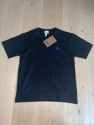 Burberry T-shirt  - Black T-shirt with Blue logo. Brand new Size M