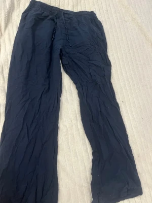 Mörkblå linnebyxor från 157 XS - Mörkblå linnebyxor från 157 med resår i midjan och raka ben. Tillverkade i mjukt och bekvämt material, perfekta för chill dagar. Klassisk modell utan synliga loggor eller detaljer.