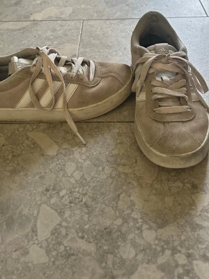 Ljusrosa Adidas sneakers  - Säljer ett par ljusrosa sneakers som har missfärgats lite från Adidas med klassiska vita ränder på sidan, man ser att de har tecken på använd men rätt snygga ändå!!❤️