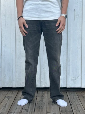 Svarta raka jeans med vintagekänsla - Säljer ett par svart tvättade Levis 555 i storlek w 32 / L 34. OBS dom är lite uppklippta nere vid byxbenet