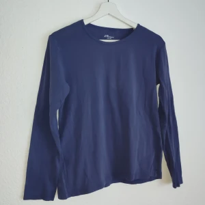 Mörkblå långärmad tröja från EP Collection - Säljer en stilren mörkblå långärmad tröja från EP Collection. Perfekt för en avslappnad look. Tröjan har en enkel design och är tillverkad i ett mjukt material.