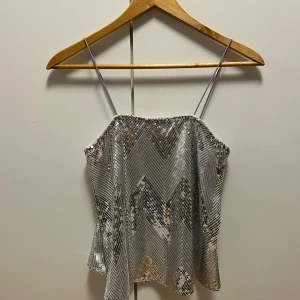 Glittrig topp - Jättegulligt glittrigt paljett linne med spagetti band! Den perfekta festtoppen under en kavaj t.ex💕Endast använd 2 gånger, mycket bra skick inga defektheter! True to size strl 36🩷