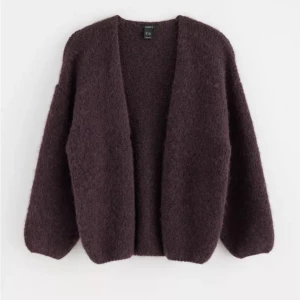 lila/röd kofta från lindex - Mysig och fluffig kofta från Lindex. Perfekt för kyliga dagar med sin öppna design och långa ärmar. Ett måste för garderoben!