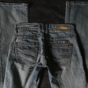 lågmidjade bootcut - lågmidjade bootcut jeans med detaljer på fickorna 