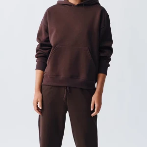 Brunt set - Säljer en supermjuk och bekväm brunt set hoodie med tillhörande byxor. Perfekt för mysiga dagar eller en avslappnad stil. Hoodien har en stor ficka fram och en klassisk huva. Passar perfekt till höst och vinter! Helt nytt set med prislappen på.