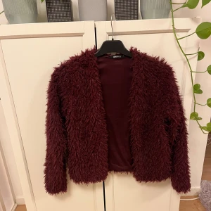 Fluffjacka/kofta - Superfin jacka/kofta i en fin vinröd färg, den är i stl S och köpt på Gina tricot. Verkligen superskönt material och håller värmen bra💕