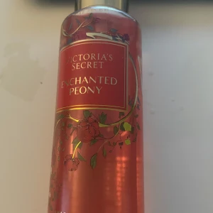 Enchanted Peony från Victoria's Secret - Enchanted Peony från Victoria's Secret är en parfym med en blommig doft. Flaskan är rosa med ett dekorativt blommönster och har en elegant design. Perfekt för den som älskar en romantisk och förtrollande doftupplevelse. Ungefär 200 ml eller mer  av den är kvar av 250.