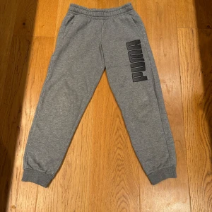 Gråa puma byxor - Har ett par gråa puma byxor som jag tänkte sälja. Byxorna har inte används så mycket och ser ut som nya. Storlek:152