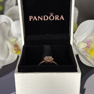 Pandora ring med upphöjt hjärta - Pandora Ring med glittrande hjärta, storlek 54, roséguldpläterad. Stilren och romantisk ring med ett glittrande hjärta, roséguldpläterad för en elegant finish. Perfekt som present eller till dig själv. Skick 10/10, använd vid få tillfällen. Pris kan diskuteras vid snabb affär!