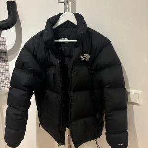 Svart dunjacka från The North Face - Säljer en svart dunjacka från The North Face i storlek M.  Den har en dragkedja framtill och är långärmad. Märket syns tydligt på bröstet och ryggen. ❤️aldrig direkt använd så super bra skick. 