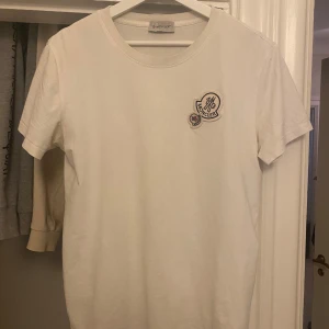 moncler t shirt - Säljer en stilren vit t-shirt från Moncler i bomull |Den har en broderad Moncler-logga på bröstet  | Perfekt för både vardag och fest | T-shirten har en normal passform | storlek S