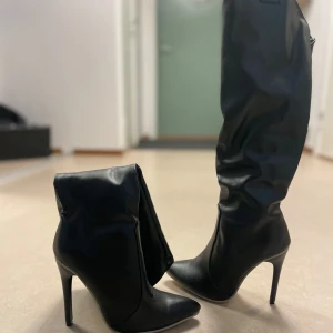 Svarta stövlar med klack - Snygga svarta stövlar i skinn med hög klack och spetsig tå. Perfekta för en utekväll eller fest. De är i mycket bra skick och ger en elegant look. Helt oanvända. Passar bra till både kjol och byxor. För små för mig och köptes för 999kr