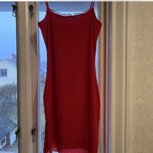 Röd klänning från H&M Divided - Snygg röd klänning från H&M Divided i storlek XS. Klänningen är ärmlös med smala axelband och har en enkel och stilren design. Perfekt nu till jul 🩷