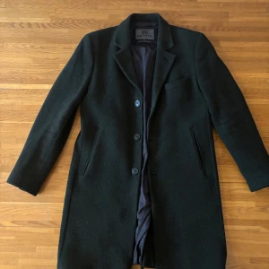  Grön rock från Brixtol - Snygg grön rock från Brixtol i storlek M. Kappan har en klassisk design med knappar framtill och långa ärmar. Perfekt för kyligare dagar med sitt stilrena utseende.