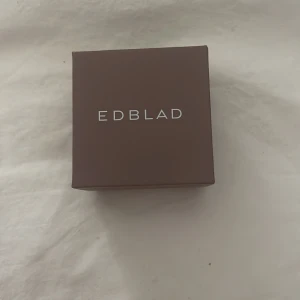 Silverörhänge med kedja från Edblad - Elegant silverörhänge från Edblad med en tunn kedja och en gnistrande sten. Perfekt för att ge en stilren touch till din look. Kommer i originalförpackning.