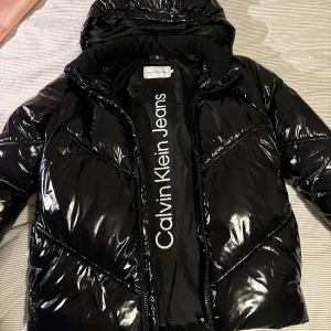 Glansig Calvin Klein vinterjacka - Köpt förra året för ca 1500 kr, barnstorlek (står ”16år” på lappen) men passar XS-S. Väldigt bra skick💕